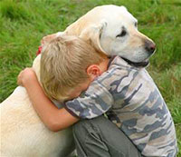 Boy hugs a dog
